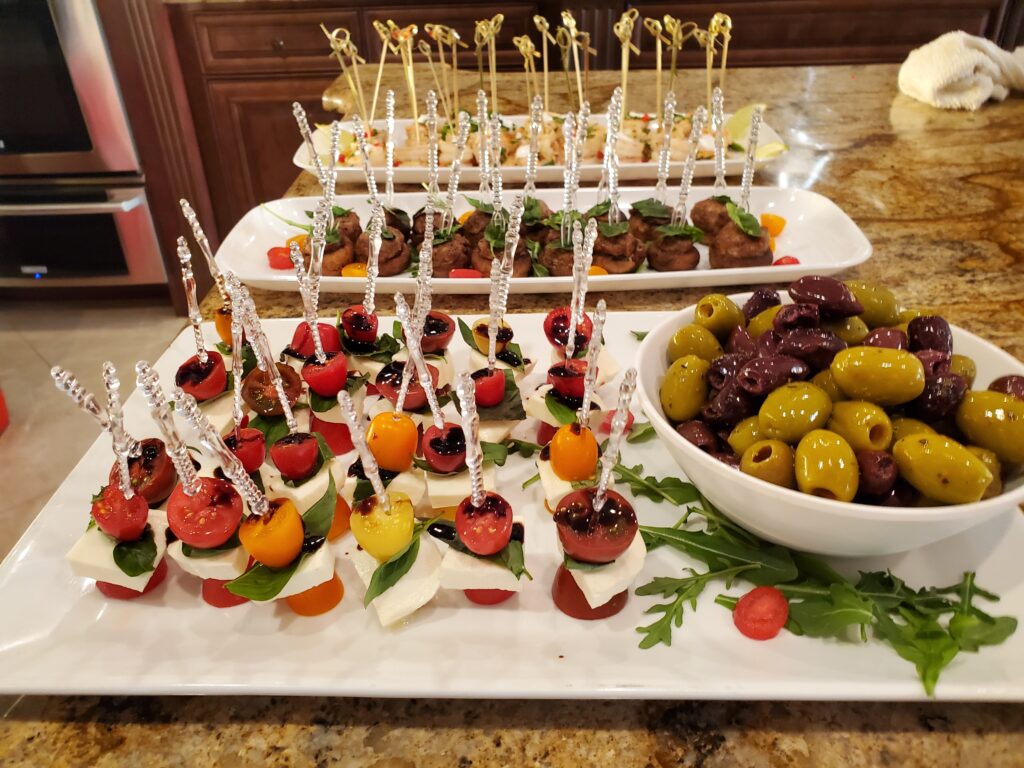 Caprese skewers with olives and arugula.
