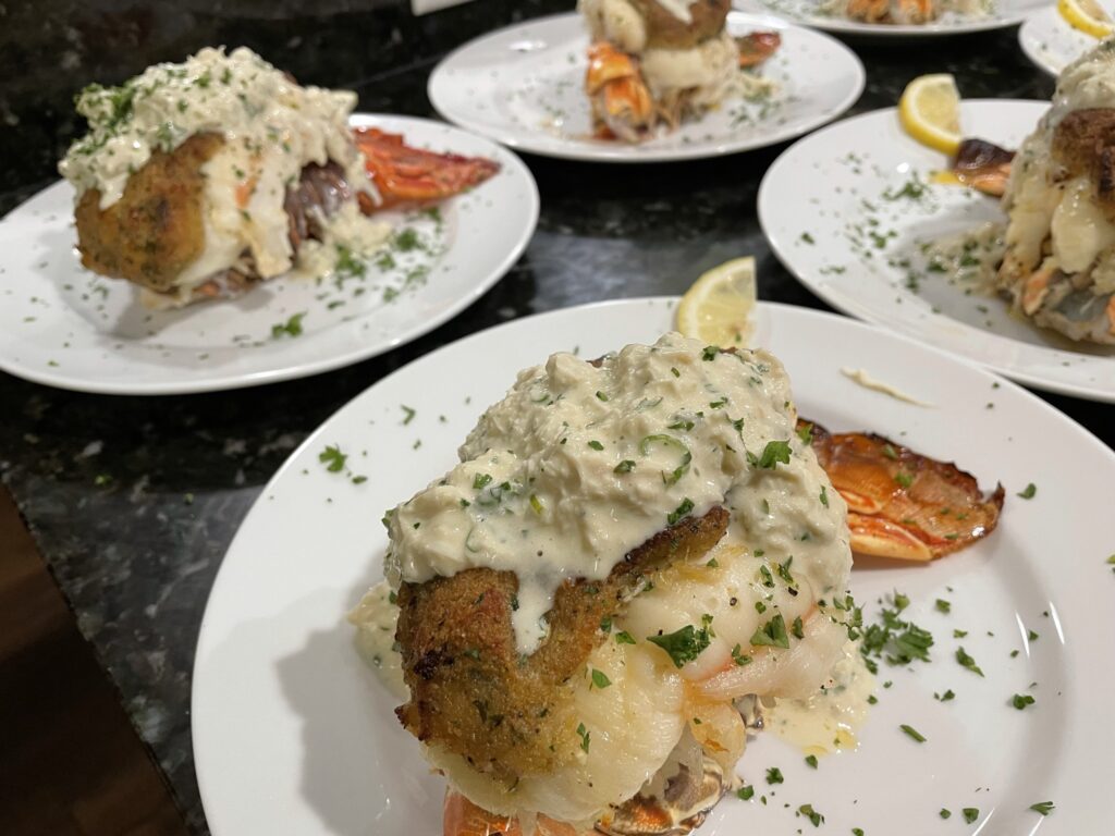 Lobster tail with creamy sauce and herbs.