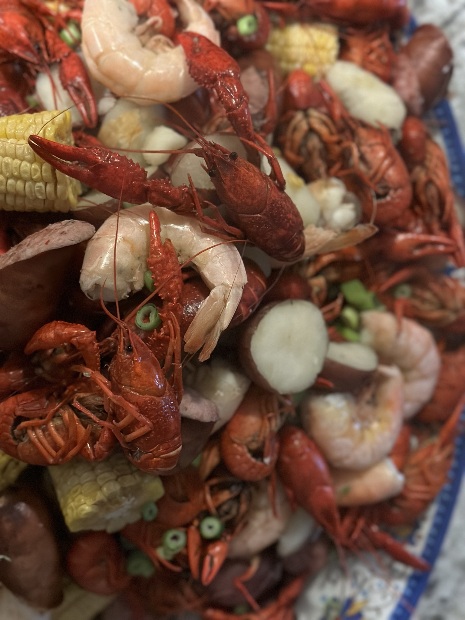 A plate of crawfish and corn on the cob.