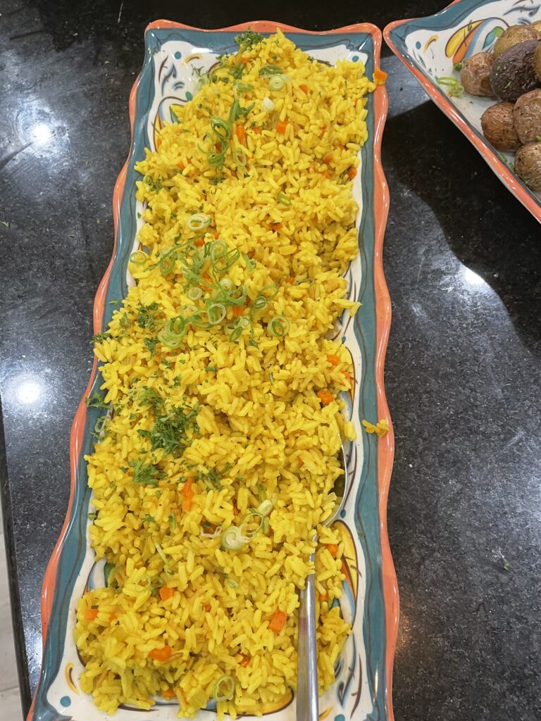 A plate of rice and vegetables on the table.