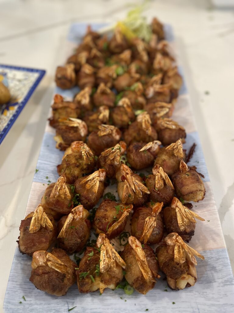 A long table with many different kinds of food.