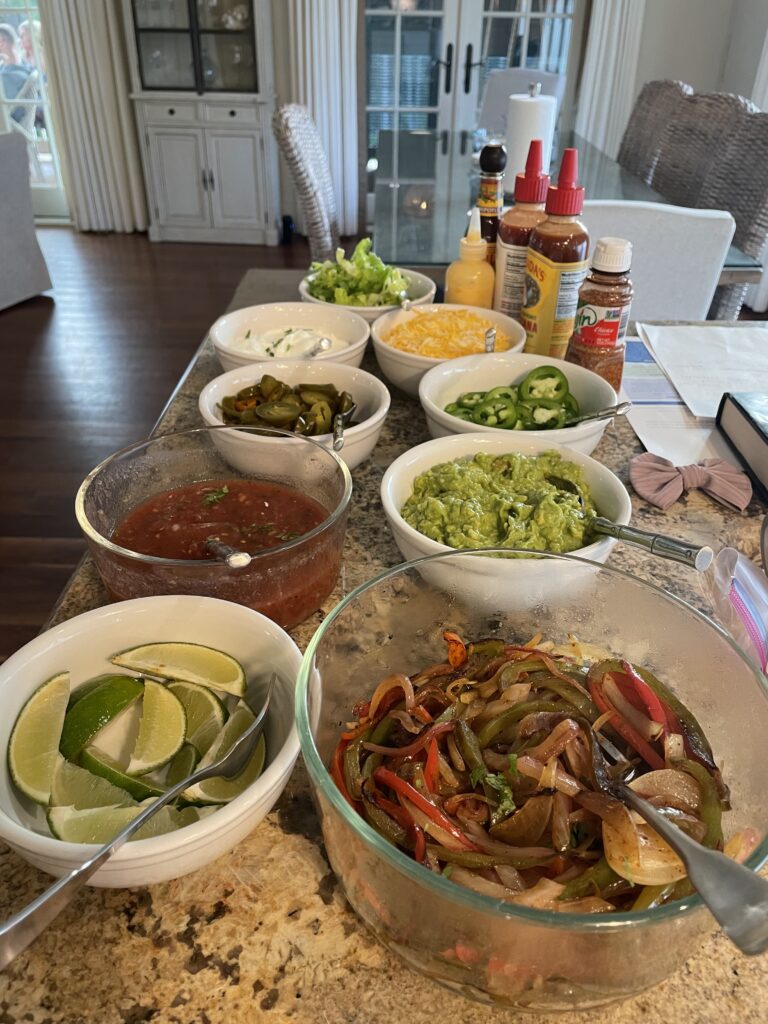A table with many bowls of food on it